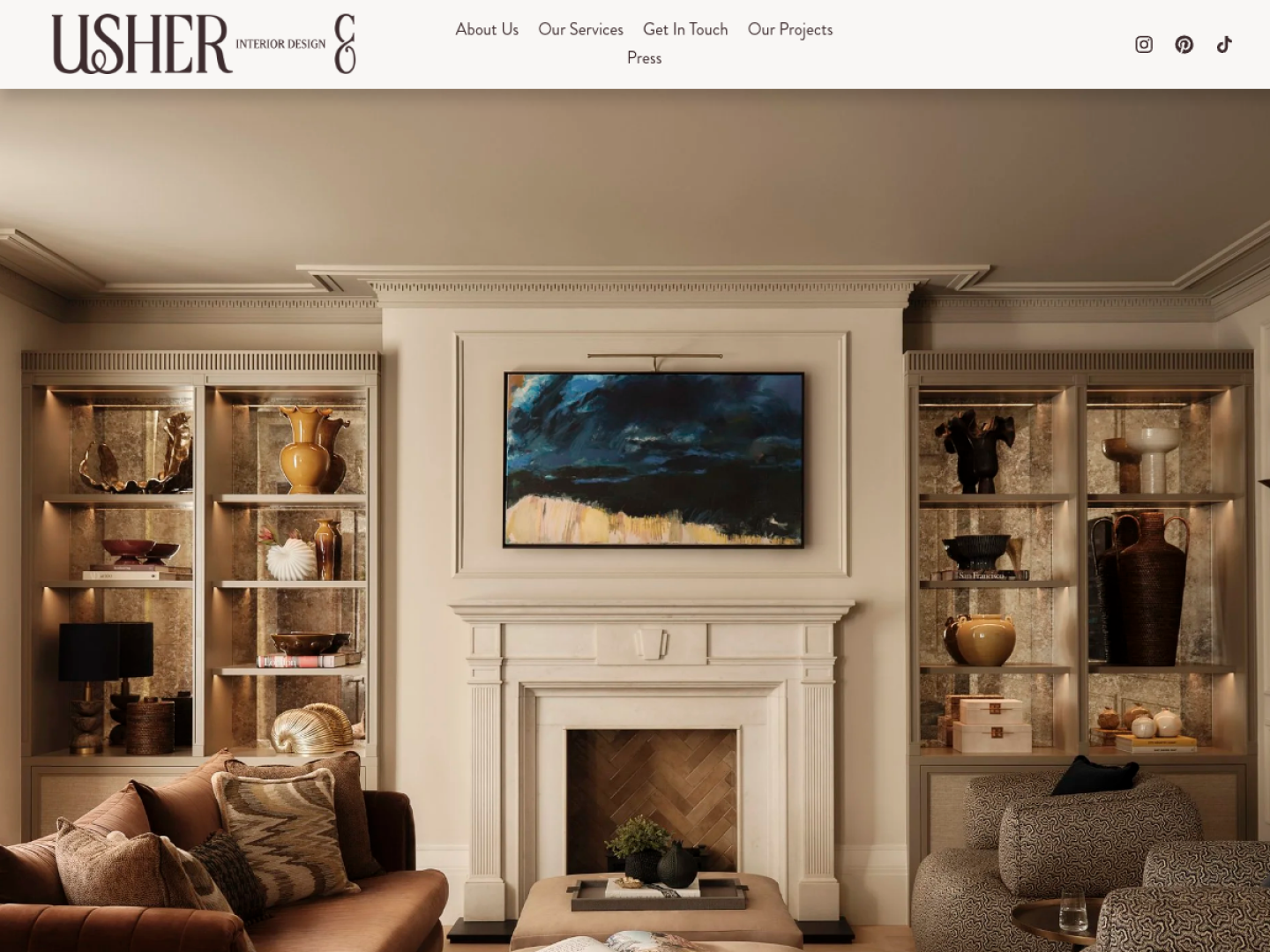Usher & Co homepage, with a full-width photo of a living room with lit shelving and a fireplace under a slim navigation bar